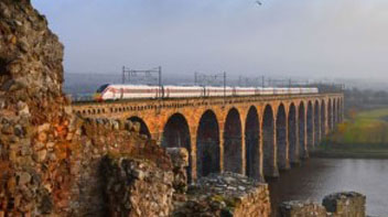 An LNER train travelling over a viaduct
