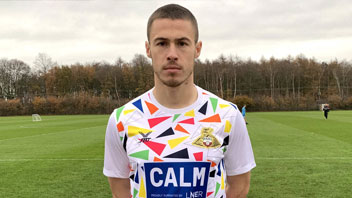 A footballer wearing a shirt sponsored by CALM