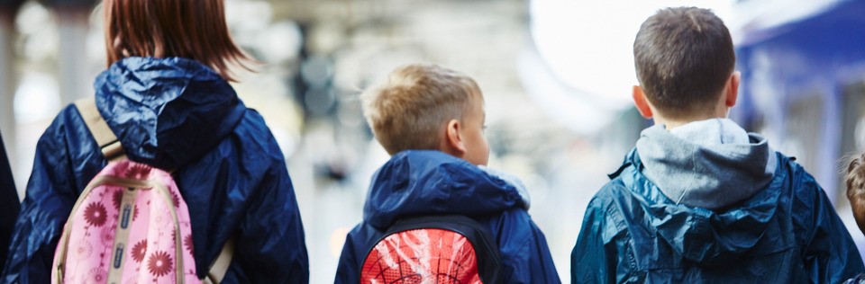 A family travelling with backpacks